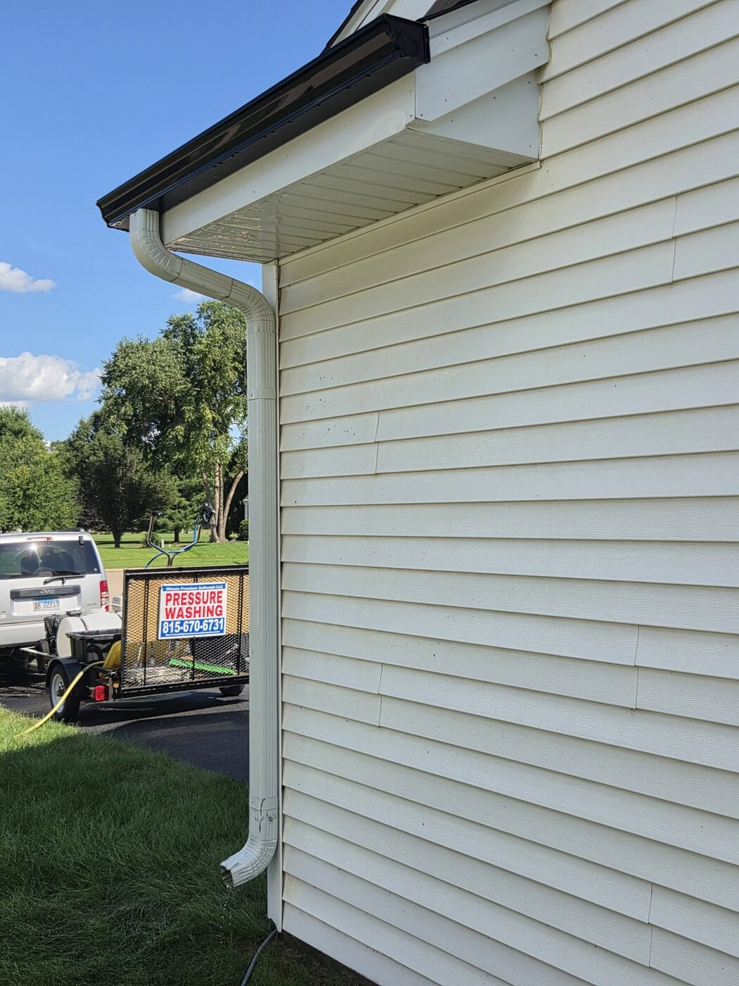 The same stretch of siding washed back to clean pale cream