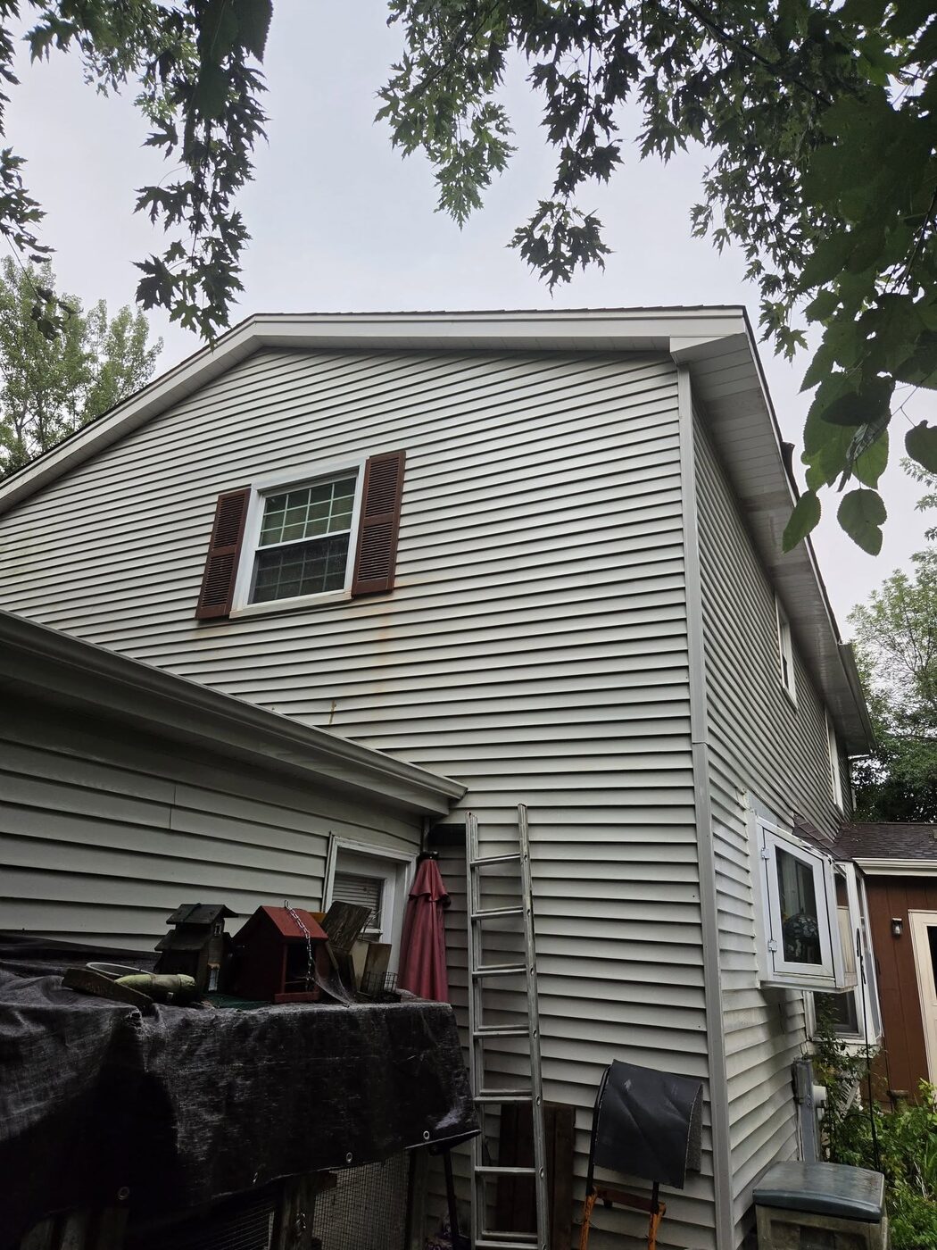The same home after a soft wash, the upper siding clean and even
