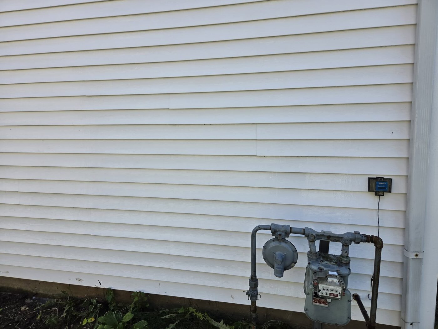The same wall after washing, the siding bright white and evenly clean